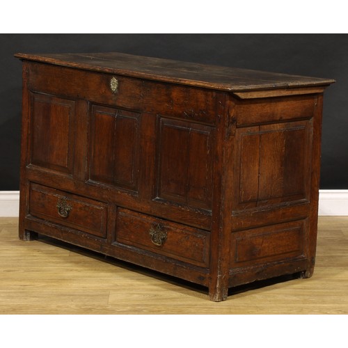 1896 - A George III oak mule chest, hinged top above a three panel front and two short drawers, 79cm high, ... 