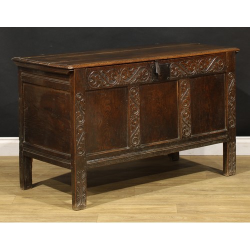 1681 - A Charles II oak blanket chest, hinged top above a carved three panel front, stile feet, 75cm high, ... 