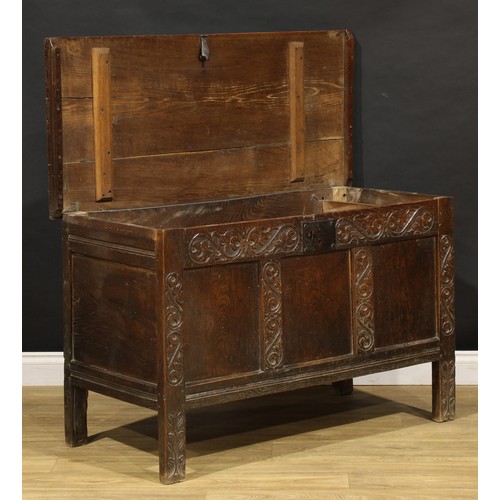 1681 - A Charles II oak blanket chest, hinged top above a carved three panel front, stile feet, 75cm high, ... 