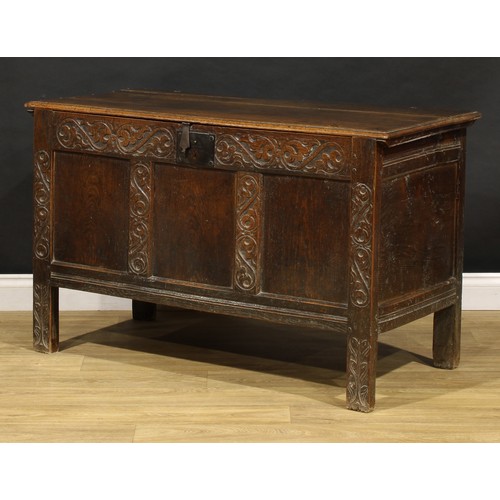 1681 - A Charles II oak blanket chest, hinged top above a carved three panel front, stile feet, 75cm high, ... 