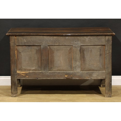 1681 - A Charles II oak blanket chest, hinged top above a carved three panel front, stile feet, 75cm high, ... 