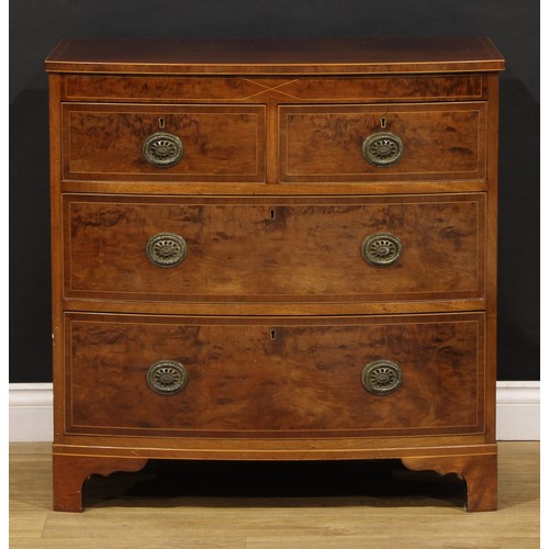 1734 - A George III mahogany bowfront chest, of two short and two long drawers, brass laurel wreath ring ha... 