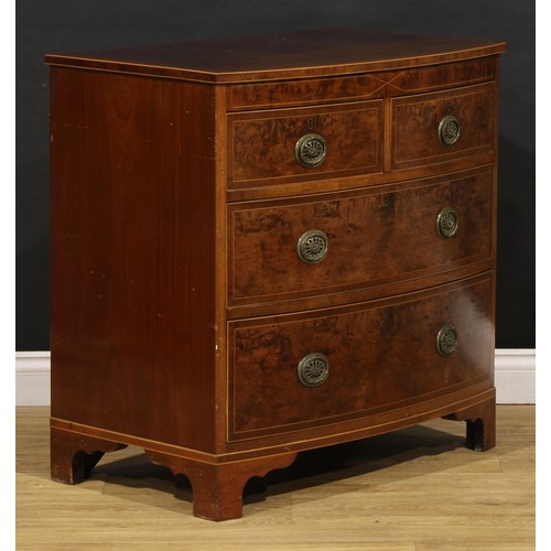 1734 - A George III mahogany bowfront chest, of two short and two long drawers, brass laurel wreath ring ha... 