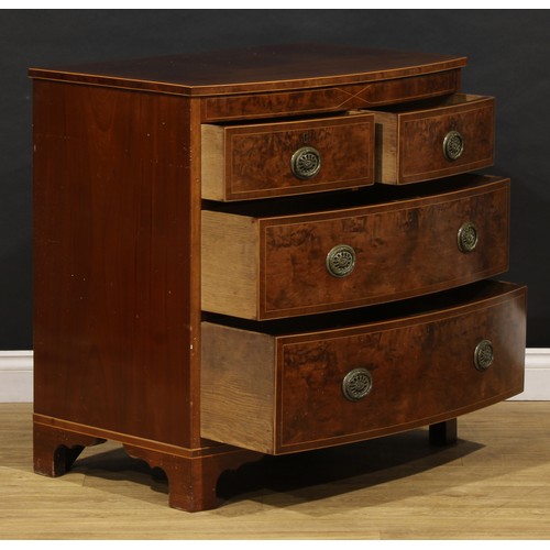 1734 - A George III mahogany bowfront chest, of two short and two long drawers, brass laurel wreath ring ha... 