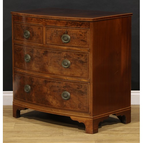 1734 - A George III mahogany bowfront chest, of two short and two long drawers, brass laurel wreath ring ha... 