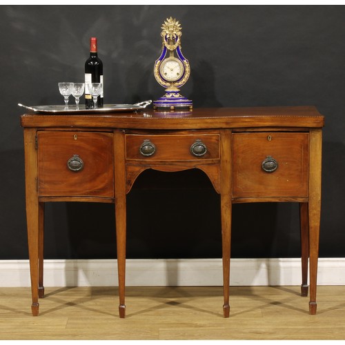 1685 - A George III Revival mahogany serpentine serving table, oversailing top outlined with barber pole st... 