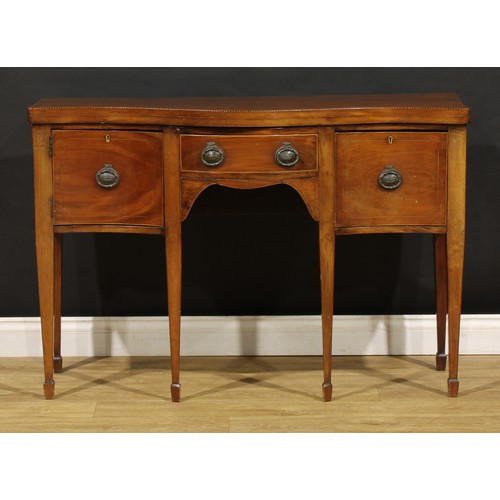 1685 - A George III Revival mahogany serpentine serving table, oversailing top outlined with barber pole st... 