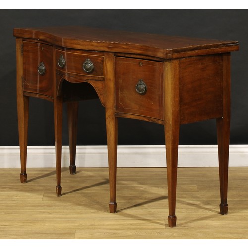 1685 - A George III Revival mahogany serpentine serving table, oversailing top outlined with barber pole st... 