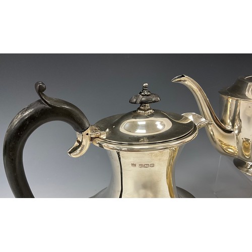 223 - A George V silver four piece tea service, comprising teapot, hot water jug, milk jug and twin handle... 