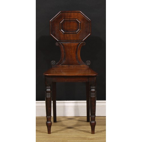 1610 - A pair of George/William IV mahogany hall chairs, each shaped back with octagonal cresting above C-s... 