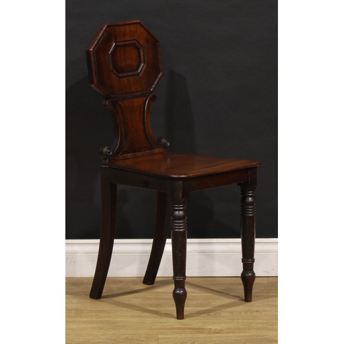 1610 - A pair of George/William IV mahogany hall chairs, each shaped back with octagonal cresting above C-s... 