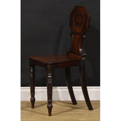 1610 - A pair of George/William IV mahogany hall chairs, each shaped back with octagonal cresting above C-s... 