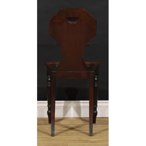 1610 - A pair of George/William IV mahogany hall chairs, each shaped back with octagonal cresting above C-s... 