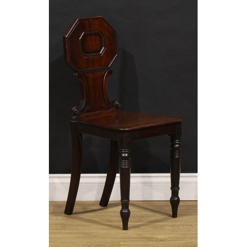 1610 - A pair of George/William IV mahogany hall chairs, each shaped back with octagonal cresting above C-s... 