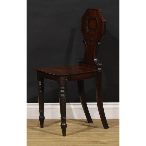 1610 - A pair of George/William IV mahogany hall chairs, each shaped back with octagonal cresting above C-s... 