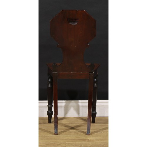 1610 - A pair of George/William IV mahogany hall chairs, each shaped back with octagonal cresting above C-s... 