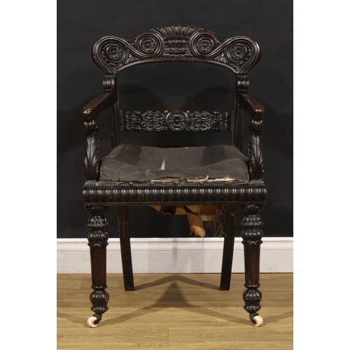 1530 - A 19th century Anglo-Indian padouk bar-back desk chair, carved throughout with floral and foliate mo... 