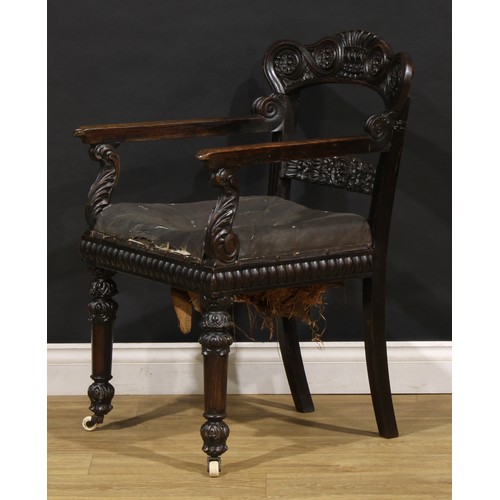 1530 - A 19th century Anglo-Indian padouk bar-back desk chair, carved throughout with floral and foliate mo... 