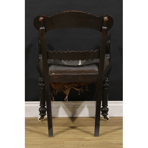 1530 - A 19th century Anglo-Indian padouk bar-back desk chair, carved throughout with floral and foliate mo... 