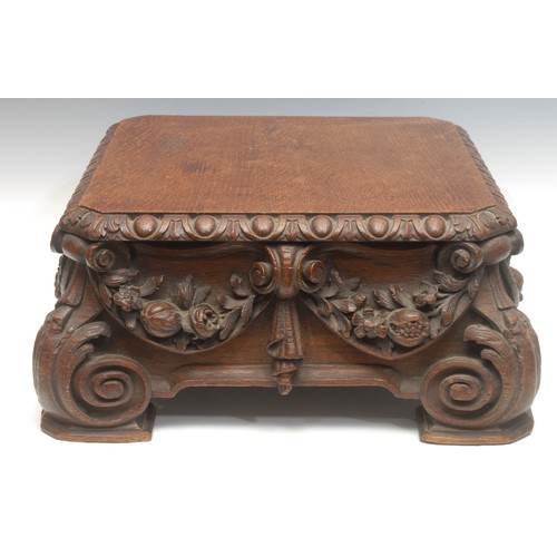 1546 - A Victorian oak pedestal base, the canted square top with oval bosses above profusely carved flowers... 