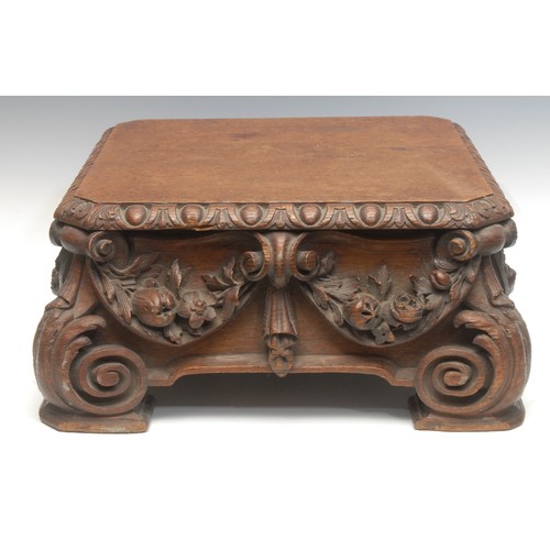 1546 - A Victorian oak pedestal base, the canted square top with oval bosses above profusely carved flowers... 