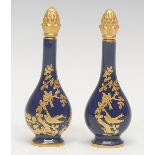 1224 - A pair of Lynton porcelain baluster scent bottles, decorated in gilt with birds amongst foliage, des... 