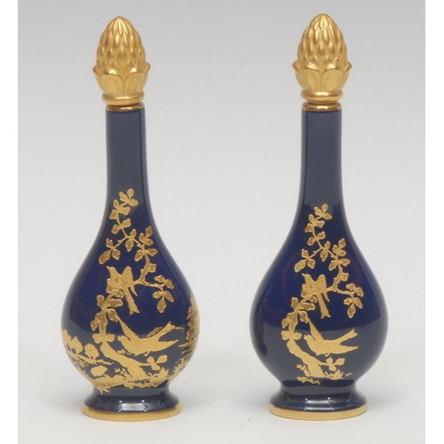 1224 - A pair of Lynton porcelain baluster scent bottles, decorated in gilt with birds amongst foliage, des... 