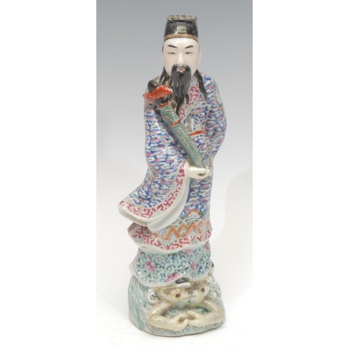 1231 - A Republic Period Chinese porcelain figure, of a warrior standing on a frog, decorated in the Famill... 