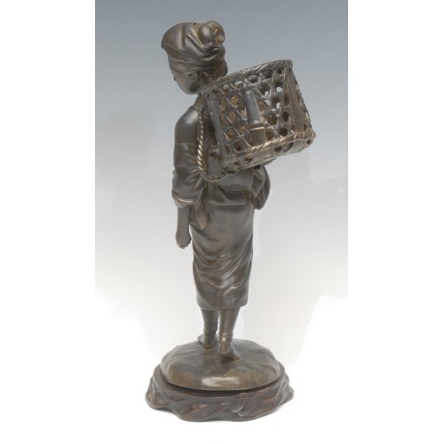 1647 - A Japanese figural bronze, of a woman in trian aspect, carrying a tea leaf basket, hardwood stand, 3... 