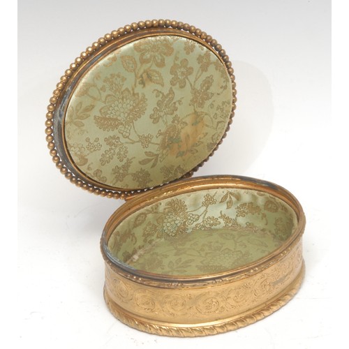 1517 - A 19th century Continental gilt metal oval sewing box, the hinged cover mounted with maidens attende... 