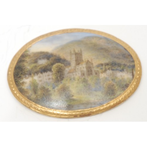 1233 - A Royal Worcester porcelain brooch plaque or panel, the domed upper hand-painted with a Gothic Reviv... 