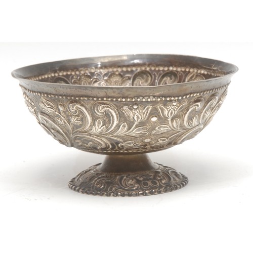 109 - A 19th century Indian silver pedestal bowl, decorated throughout with foliate scrolls in repoussé, 6... 