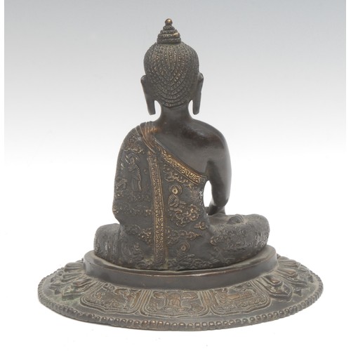 1707 - A 19th century Indian patinated bronze, as a Buddha sitting on a lotus leaf, 17.5cm high overall