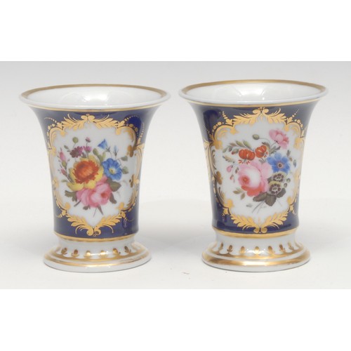 1294 - A pair of Chamberlains Worcester flared cylindrical vases, painted with flowers in a gilt foliate re... 