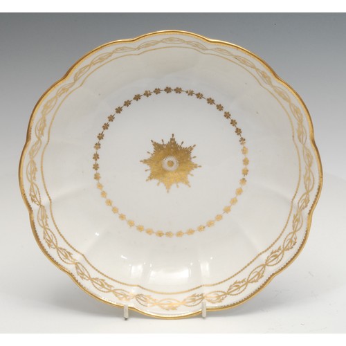 1331 - A large Derby porcelain lobed circular dish, decorated in gilt, the field decorated with sunburst, f... 