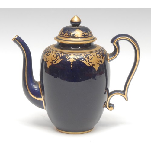 1351 - A Sevres porcelain ovoid teapot and cover, raised gilt decoration on a cobalt blue ground, 17cm high... 