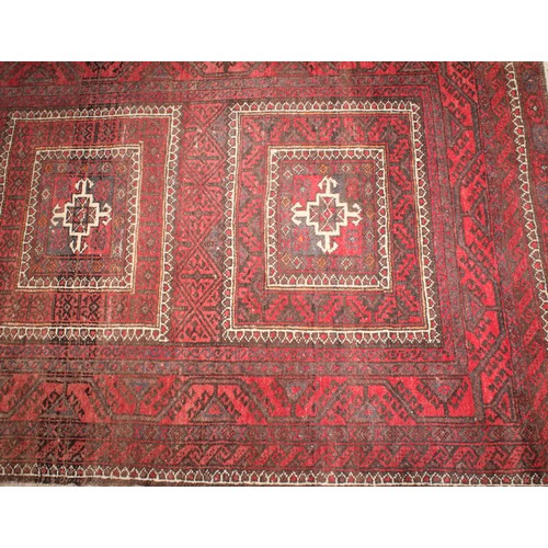 2054 - A Belouch hand knotted rug, with traditional motifs  in tones of red, black, brown, cream, approx 17... 