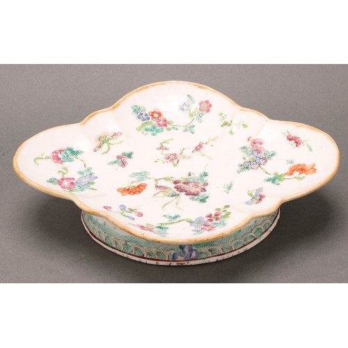 1403 - A Chinese lobed quatrefoil footed dish, painted in polychrome enamels with flowers, peaches and bats... 