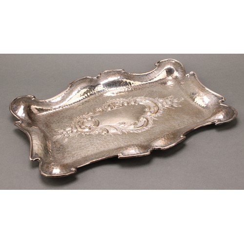 340 - An Art Nouveau silver shaped rectangular dressing table tray, the field chased with a flower and lea... 