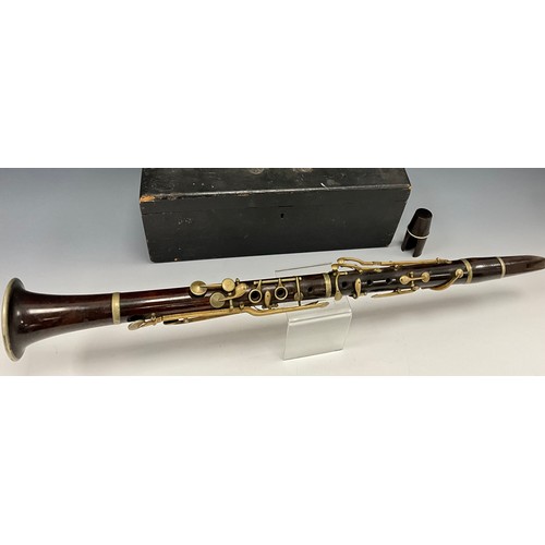 1469 - A late 19th century rosewood clarinet, unsigned four section body, silver plated mounts and valves, ... 