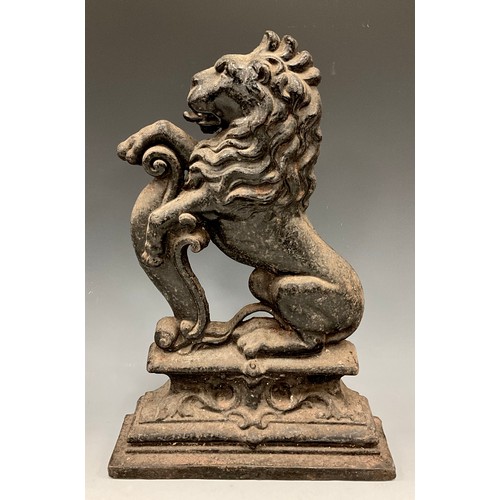 1661 - A cast iron door porter, as a rearing lion, stepped foot, 38.5cm high