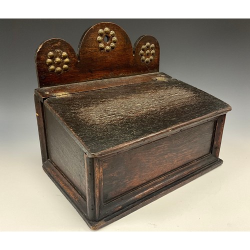 2116 - An unusual 19th century oak candle box, possibly Welsh, shaped cresting decorated with brass studs, ... 