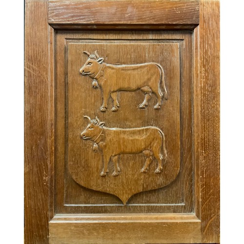 1804 - A 19th century French oak armorial panel, carved upon a shield with two cows, 53.5cm high, 43.5cm wi... 