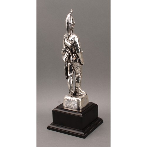 191 - Military Interest - an Elizabeth II silver coloured metal presentation figure, an officer of the 4th... 