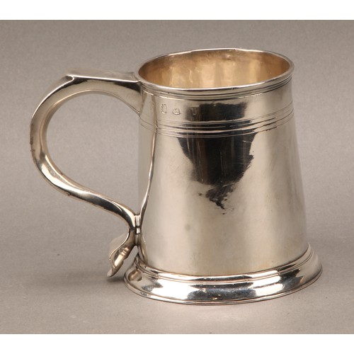 262 - A George I silver spreading cylindrical beer mug, scroll handle, reeded quarter-girdle, skirted base... 