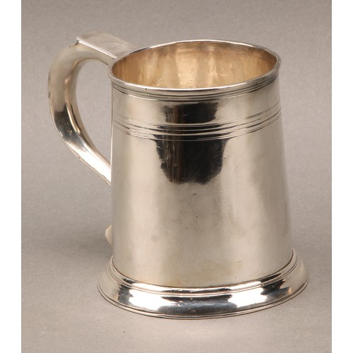 262 - A George I silver spreading cylindrical beer mug, scroll handle, reeded quarter-girdle, skirted base... 