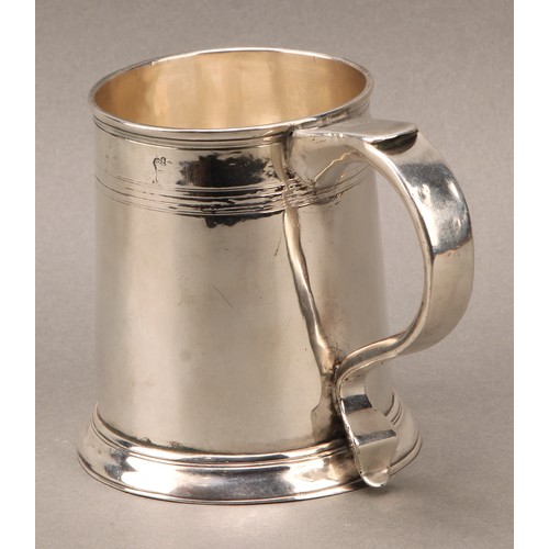 262 - A George I silver spreading cylindrical beer mug, scroll handle, reeded quarter-girdle, skirted base... 