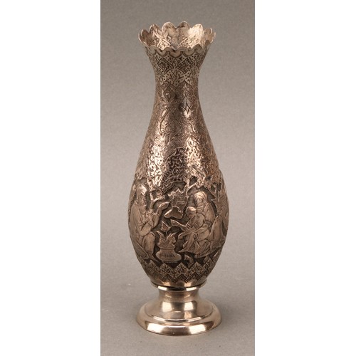 487 - An Iranian silver slender baluster vase, chased with  narrative scenes on a dense lotus ground, 18cm... 