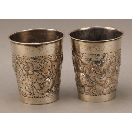 394 - A pair of large Danish silver tapered cylindrical beakers, chased with flowers and scrolling leaves,... 