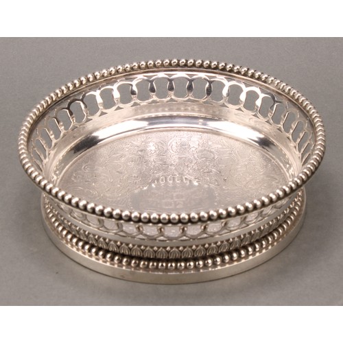 207 - A set of four 19th century French cast silver wine coasters, of substantial gauge, pierced and beade... 